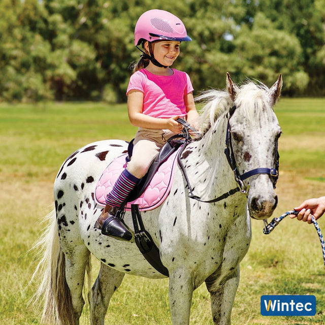 Young girl on a spotted pony in a Wintec Kids saddle